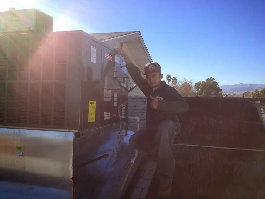 HVAC technician performing HVAC Inspection on a rooftop unit in Gallatin